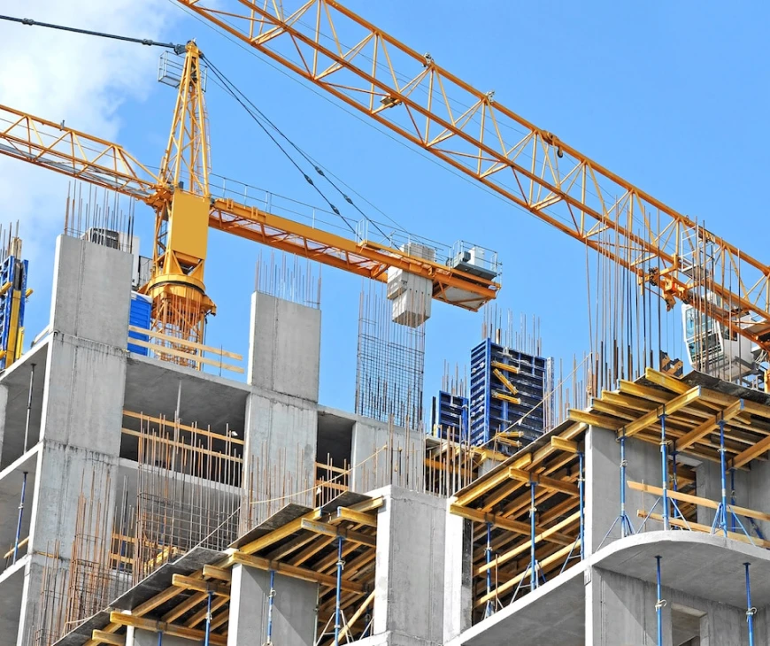 Tower cranes above concrete building frames under construction